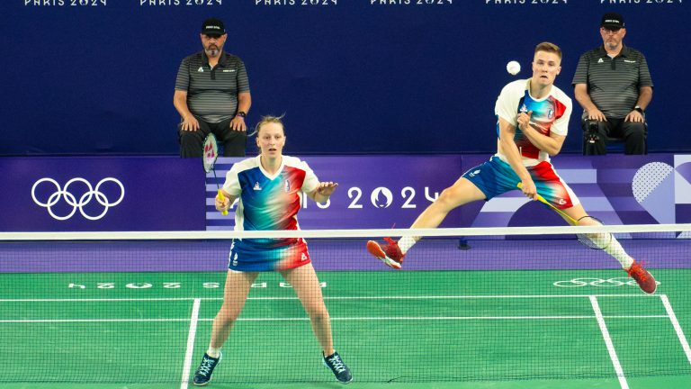 Thom Gicquel smasher i luften mens Delphine Delrue dækker forbanen i den franske landsholdsdragt ved OL i Paris 2024
